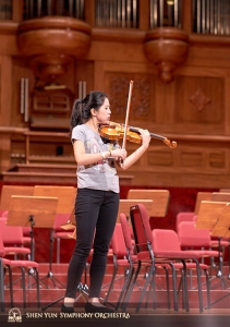 La solista di violino Fiona Zheng prova la risonanza della sala