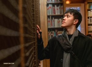 Monty Mou scorre i ripiani pieni di libri di danza e opera alla biblioteca-museo del Palais Garnier (foto di Andrew Fung). 